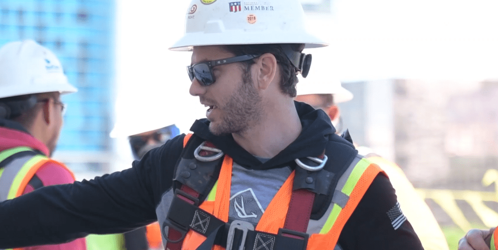 Roofer wearing safety gear.