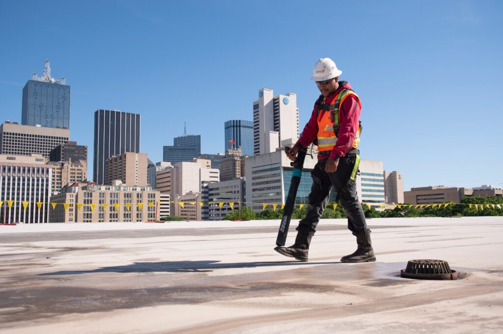 Man cleaning commercial roof.